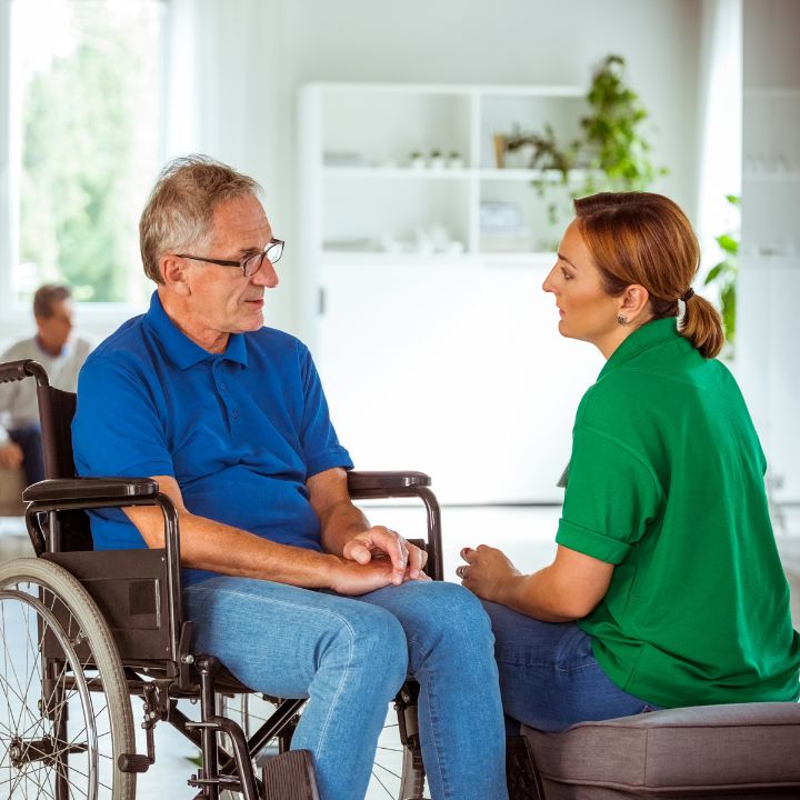 Support Worker Helping Person on Wheelchair